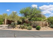 Stunning desert landscaping graces this property, complementing its unique architectural design at 40215 N 110Th Pl, Scottsdale, AZ 85262