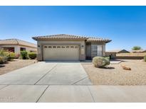 Single-story home with desert landscaping, two-car garage and concrete driveway at 6319 W Hilton Ave, Phoenix, AZ 85043