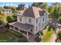 Aerial view showcases a lovely home with a covered porch and a well-maintained lawn at 7252 N Central Ave, Phoenix, AZ 85020