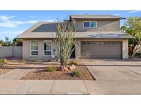 Inviting two-story home featuring a well-maintained yard and a spacious two-car garage at 1411 W Mendoza Ave, Mesa, AZ 85202