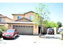 Charming two-story home with a well-maintained front yard and a spacious two-car garage at 1417 E Rosebud Dr, San Tan Valley, AZ 85143