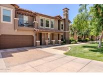 Beautiful two-story home with a balcony, well-kept yard, and attached garage at 14250 W Wigwam Blvd # 121, Litchfield Park, AZ 85340