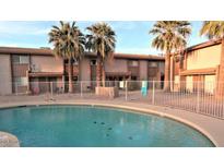 Community pool with palm trees at this townhome complex at 1750 E Mateo Cir # 106, Mesa, AZ 85204