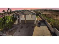 Beautiful two story home with a large driveway, two-car garage, tile roof and desert landscaping at 23214 N 106Th Ave, Peoria, AZ 85383
