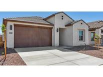 Charming single-story home showcasing a two-car garage and landscaped front yard at 23419 W Albeniz Pl, Buckeye, AZ 85326