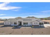 Stunning single-story home with white siding, dark trim, and desert landscaping at 3933 E Freeman Ln, San Tan Valley, AZ 85140