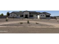A charming single-Gathering home with modern farmhouse architecture and a well-manicured gravel front yard at 3933 E Freeman Ln, San Tan Valley, AZ 85140