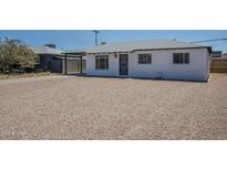 Charming single-story home with rock landscaping, black trim, and shaded carport at 4209 N 48Th Dr, Phoenix, AZ 85031