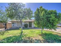 Charming single-story home featuring a well-maintained lawn and mature shade trees at 5038 N 20Th Ave, Phoenix, AZ 85015