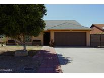 Charming single-story home featuring a well-maintained front yard and a two-car garage at 6546 N 71St Ave, Glendale, AZ 85303