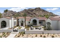Stunning home exterior showcasing a tiled roof, desert landscaping, and picturesque mountain views at 7501 N Eucalyptus Dr, Paradise Valley, AZ 85253