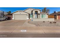 Charming single-Gathering home featuring a two-car garage, complemented by desert landscaping and a neutral color palette at 7810 W Beryl Ave, Peoria, AZ 85345