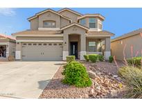 Charming two-story home with a well-manicured desert rock landscape in front at 10351 W Carlota Ln, Peoria, AZ 85383