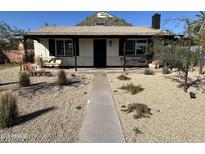 Charming single-story home featuring a covered porch and desert landscaping at 112 W Vogel Ave, Phoenix, AZ 85021