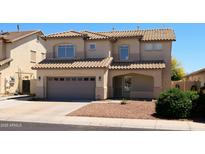 Charming two-story home with a tile roof, a two-car garage, and desert landscaping at 12209 W Washington St, Avondale, AZ 85323