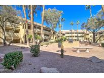 Well-maintained community area with barbecue grills, seating, and lush landscaping creating a welcoming outdoor space at 1331 W Baseline Rd # 120, Mesa, AZ 85202
