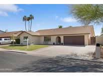 Charming single-story home featuring a well-manicured lawn, two-car garage, and a welcoming entryway at 2329 S Elm --, Mesa, AZ 85202