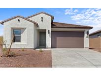Charming single-story home featuring a brown tile roof and a two-car garage at 23456 W Fulton St, Buckeye, AZ 85326