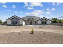 Charming one-story home featuring stone accents, low-maintenance landscaping, and a circular driveway at 3989 E Freeman Ln, San Tan Valley, AZ 85140