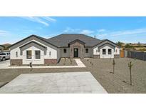 Beautiful single-story home featuring a modern design, manicured landscaping and a paved driveway at 3989 E Freeman Ln, San Tan Valley, AZ 85140