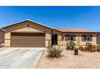 Charming single-story home featuring a two-car garage and low-maintenance desert landscaping at 40264 W Lococo St, Maricopa, AZ 85138