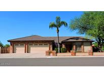 Charming single-story brick home with a three-car garage and manicured landscaping, creating great curb appeal at 6372 W Redfield Rd, Glendale, AZ 85306