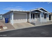 Charming single-Gathering home featuring a cozy porch, covered parking, and low-maintenance landscaping at 650 N Hawes Rd # 4007, Mesa, AZ 85207