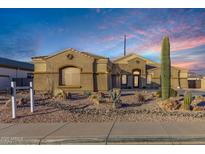 Stunning exterior view of the single story home featuring desert landscaping and a private driveway at 10040 E Grandview St, Mesa, AZ 85207