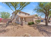 Charming two-story home featuring desert landscaping, a cozy front porch, and a classic tile roof at 12630 W Corrine Dr, El Mirage, AZ 85335