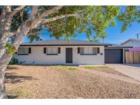 Charming home with a brick walkway, low maintenance yard, and garage at 1325 W 7Th Ave, Mesa, AZ 85202