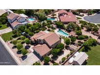 Expansive aerial view of desert home highlighting a large lot, mature trees, refreshing pool, and inviting outdoor spaces at 1532 N Ogden --, Mesa, AZ 85205