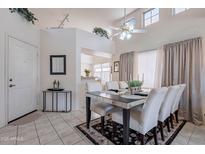 Bright dining room featuring tile floors, high ceilings, modern furniture, and plenty of natural light at 17224 N Zuni Trl, Surprise, AZ 85374