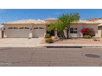 Charming single-story home featuring a three-car garage and desert landscaping at 2552 E Silverwood Dr, Phoenix, AZ 85048