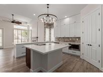 Modern kitchen featuring white cabinetry, a center island, and stainless steel appliances at 2552 E Silverwood Dr, Phoenix, AZ 85048