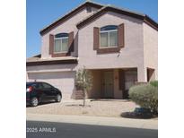Charming two-story home with a two car garage, landscaped yard, and a neutral exterior at 284 W Settlers Trl, Casa Grande, AZ 85122