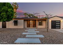 Charming home with desert landscaping, modern front door, and a detached garage at 4205 N 19Th Pl, Phoenix, AZ 85016