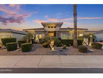 Charming single-story home featuring stone accents, desert landscaping, and warm exterior lighting at 5122 S Miller Pl, Chandler, AZ 85249