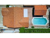 Aerial view of a charming home with a private backyard pool, red tile roof, and brick patio at 541 W Vernon Ave, Phoenix, AZ 85003