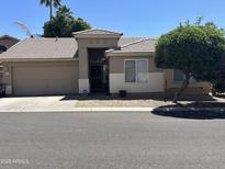 Charming single-story home with a well-maintained front yard and attached two-car garage at 6631 E Rhodes St, Mesa, AZ 85215