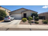 Charming single-story home with a two-car garage, low maintenance landscaping, and mature plants in the front yard at 7251 E Grouse Ct, San Tan Valley, AZ 85143