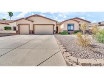 Inviting single-story home featuring a three-car garage and desert landscaping at 747 E Meadow Ln, Phoenix, AZ 85022