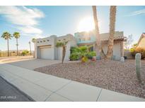 Inviting single-story home featuring desert landscaping, a two-car garage, and a unique turquoise entry at 988 W Crooked Stick Dr, Casa Grande, AZ 85122