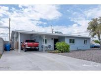 Charming single-story home featuring a carport, long driveway, and easy-care landscaping at 1017 W Piccadilly Rd, Phoenix, AZ 85013