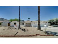 Charming single-story home featuring a two-car garage, desert landscaping, and inviting front entry at 1423 W Joan De Arc Ave, Phoenix, AZ 85029