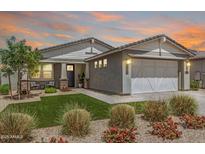 Beautiful single-Gathering home with lush landscaping, a two-car garage, and a welcoming front porch at 17362 W Wildwood St, Surprise, AZ 85388