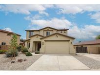 Inviting two-story home boasting a neutral color scheme, a spacious two-car garage, and low maintenance desert landscaping at 17681 W Molly Ln, Surprise, AZ 85387
