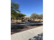 Park featuring a playground, picnic tables, mature trees, and walking paths for Gathering fun and community gatherings at 17681 W Molly Ln, Surprise, AZ 85387