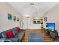 Bright living room with wood-look floors flowing into the dining and kitchen areas at 18416 N Cave Creek Rd # 3034, Phoenix, AZ 85032