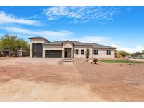 An inviting single-Gathering home featuring desert landscaping and a three-car garage at 19622 W Pasadena Ave, Litchfield Park, AZ 85340