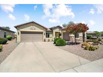 Charming home featuring a two-car garage, desert landscaping, and ample driveway space at 20140 N 269Th Dr, Buckeye, AZ 85396